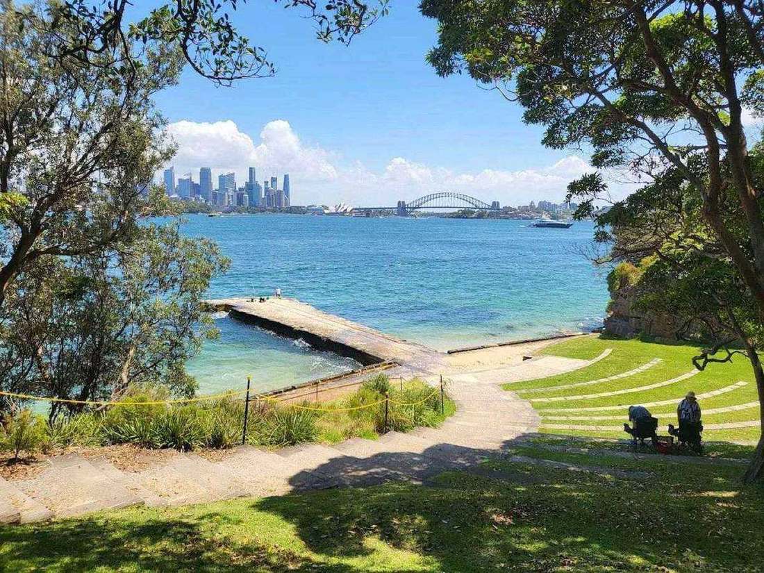 The grass amphitheatre terraces at Bradleys Head, looking across the harbour to the city, Opera House and Bridge