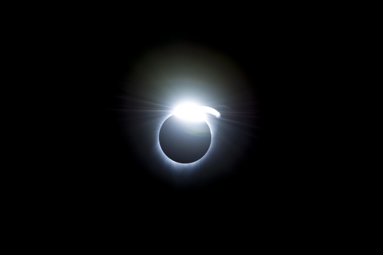 Photograph of the diamond ring effect at the end of totality, a bright flash of sunlight at the Moon's edge