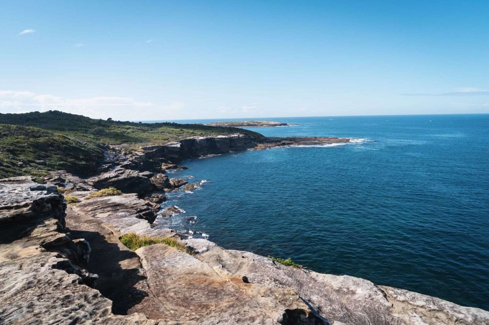 Sandstone cliffs of Kamay Botany Bay National Park at La Perouse, open water beyond