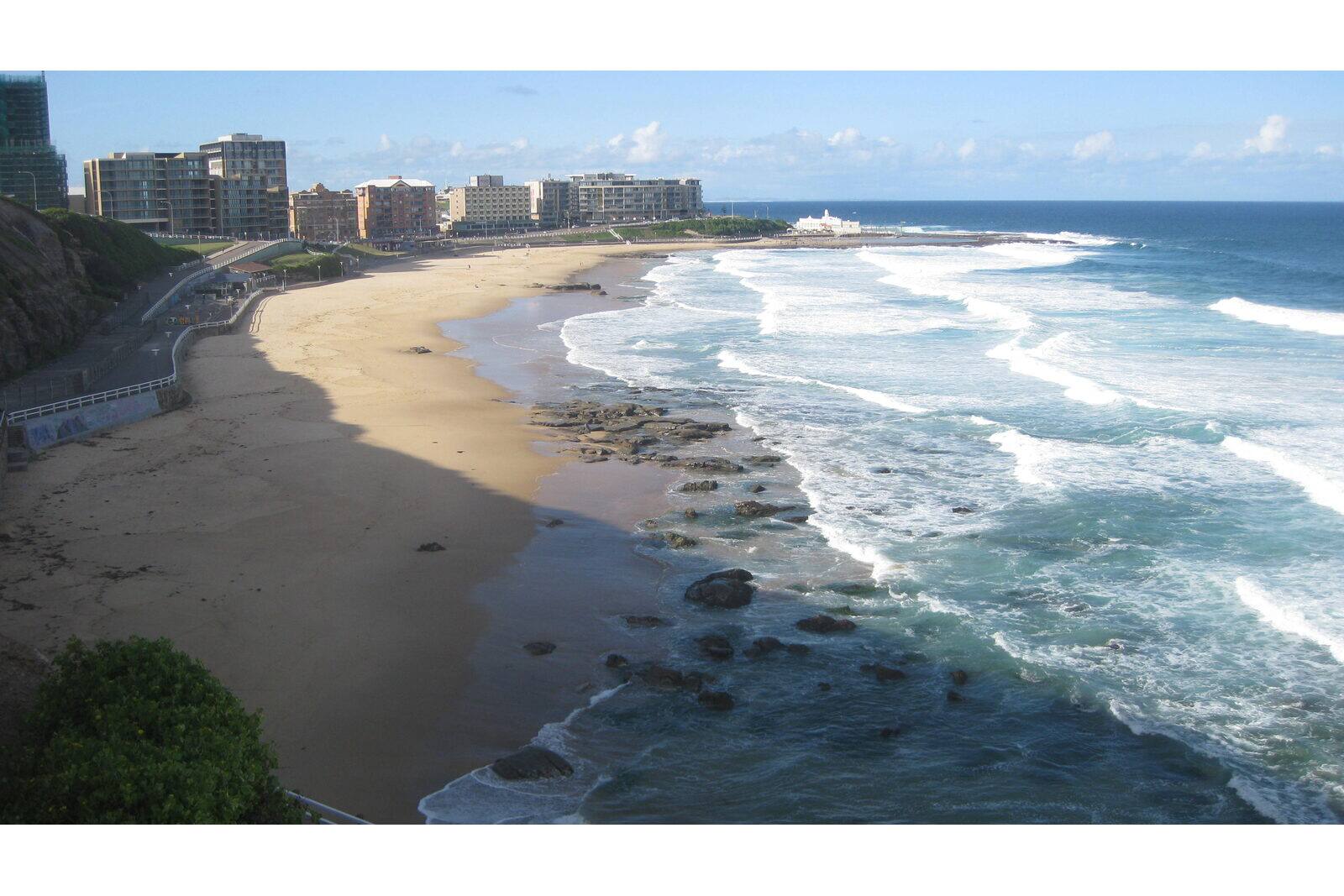 Newcastle Beach and its rock shelf from the clifftop, with the city foreshore behind, Newcastle NSW
