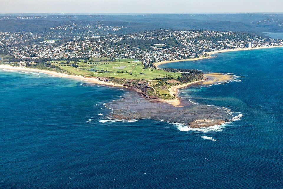 Aerial view of Long Reef headland, its rock platform and the beaches curving away to the north