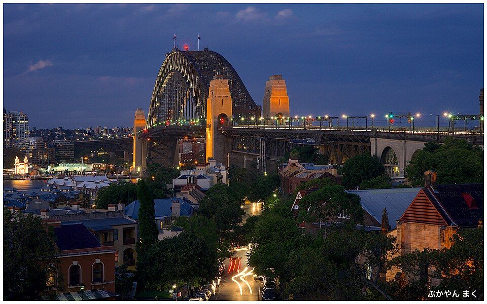 The Harbour Bridge at dusk seen from Observatory Hill, terrace rooftops in the foreground